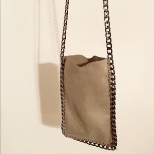 Chained cellular phone/credit card pouch.